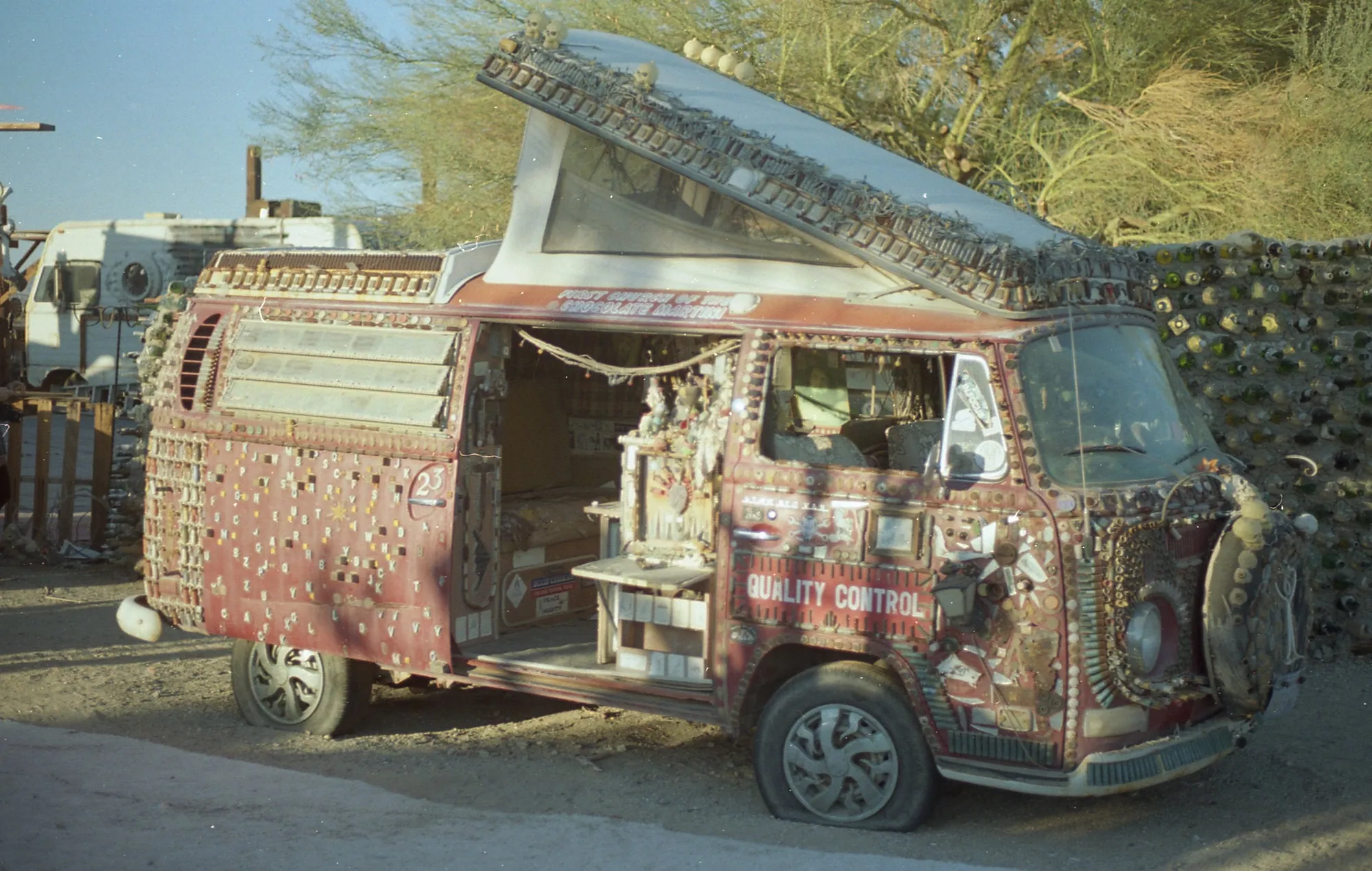 A vehicle covered in dense painted and assembled folk-art details.