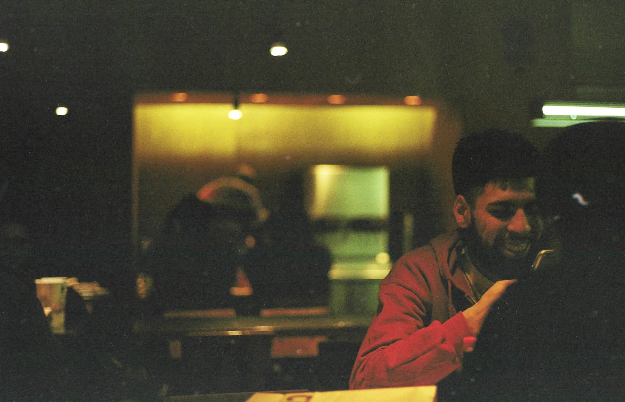 Self-portrait in a dim interior mirror.